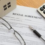 tenant agreement with pen glasses and calculator