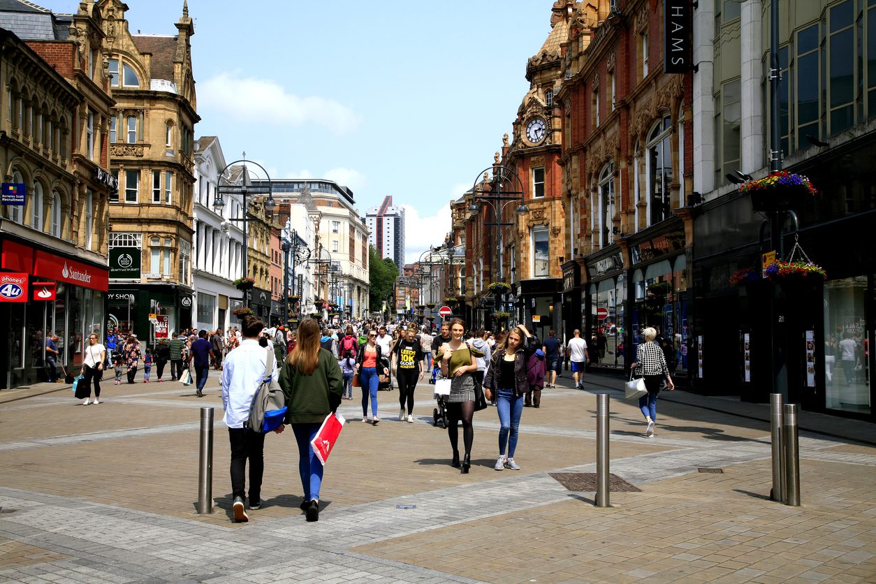 An image of Leeds' bustling city centre, full of people and historic buildings