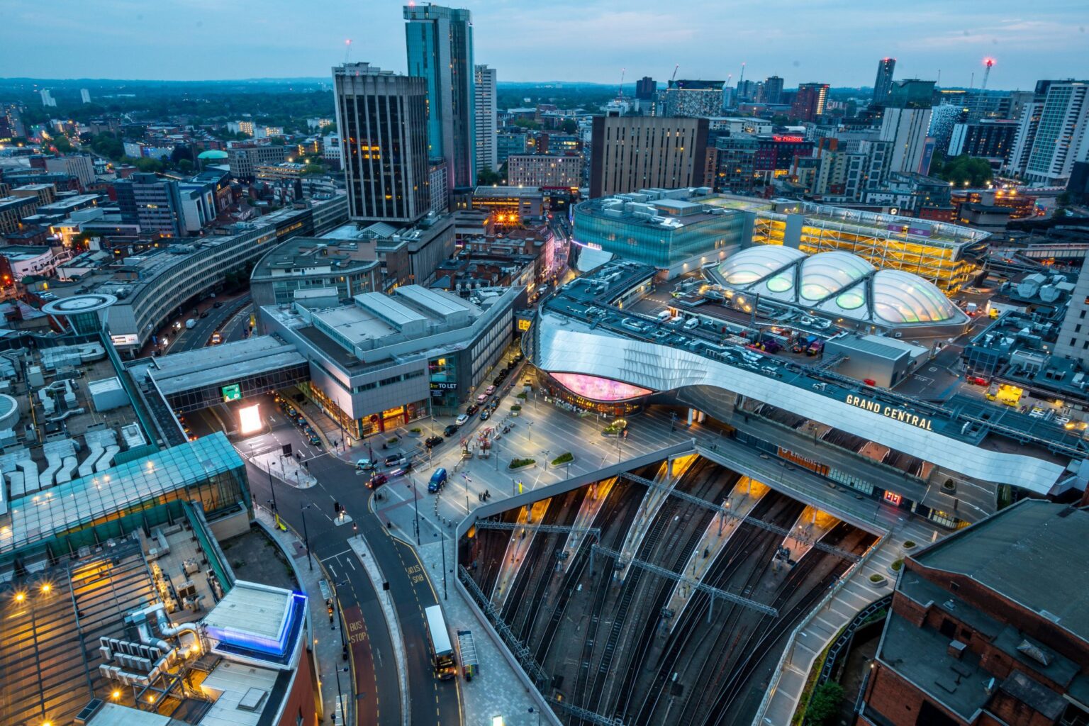 An aerial view of the city of Birmingham, showing modern properties and transport links