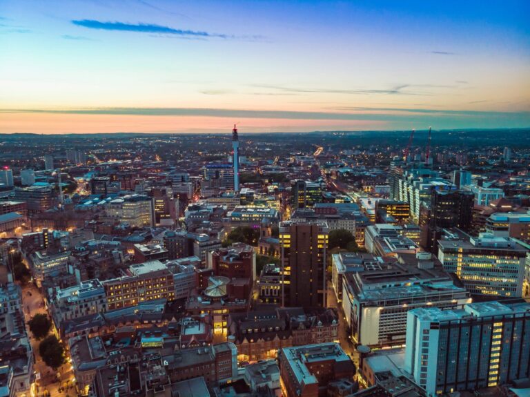 A photo of the Birmingham skyline at night, showing beautiful modern properties