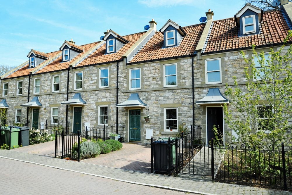 Exterior View Of Terraced Stone Cottages On A Street