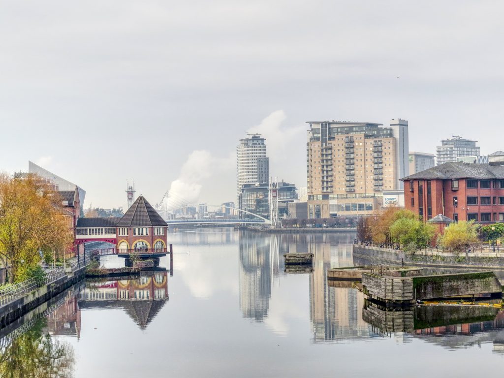 A photo of Salford Quays, Manchester, showing the Manchester Ship Canal and surrounding properties