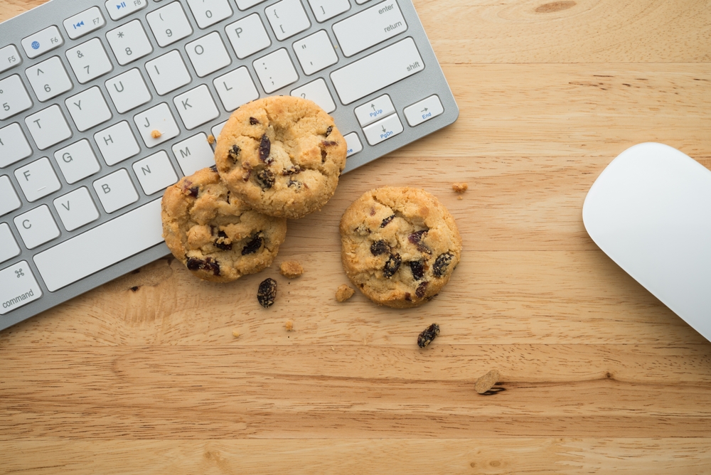 keyboard mouse and cookies on a desk