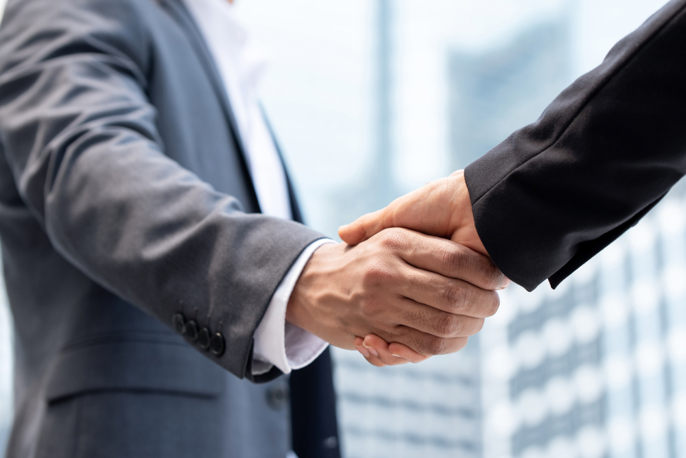 Businessmen,Making,Handshake,Outdoors,In,City,Office,Building,Background,For