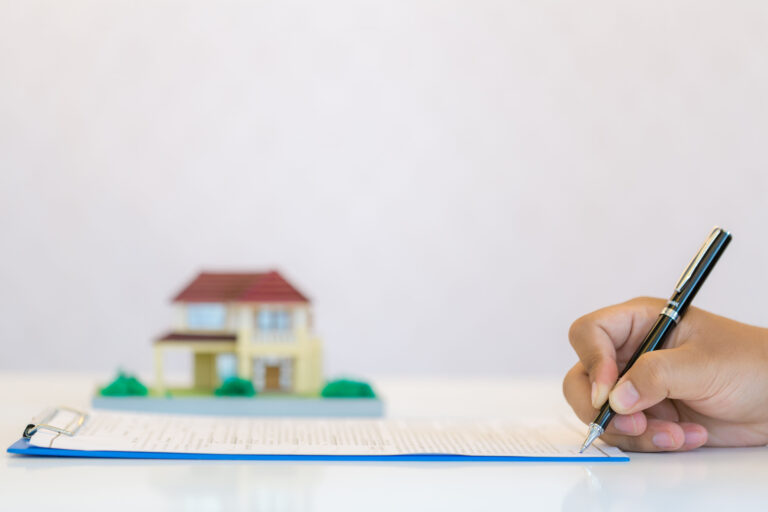 Landlord completing selective licensing paperwork for rental property under new UK council housing regulations.